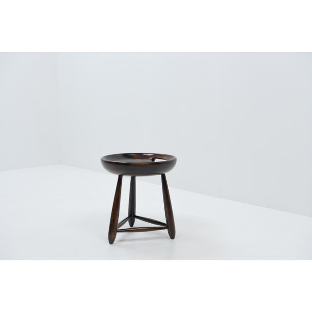 Sergio Rodrigues set the standard for Modern furniture in Brazil during the 1950s. This Mocho stool has the producer burnt...