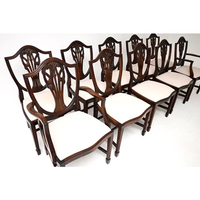 A lovely set of ten antique shield back dining chairs in the Sheraton style. They were made in England, and date from...