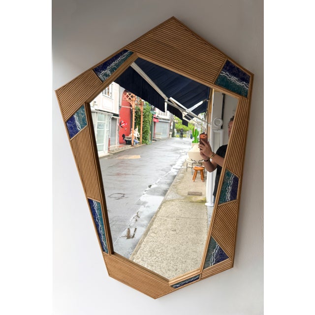 Contemporary Asymmetrical shape wall mirror in nice rattan wicker bamboo marquetry with enamel metal decor. Contemporary...