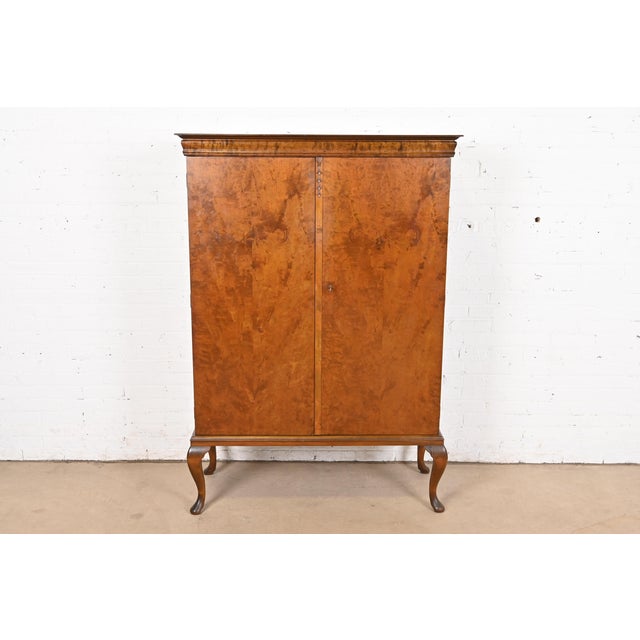 An exceptional Queen Anne style burl wood bookcase or bar cabinet In the manner of Romweber USA, Circa 1930s Measures:...