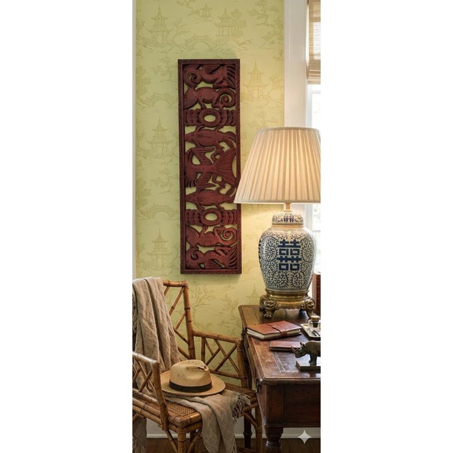 Add global character and a sense of adventure to your space with this richly hand carved wooden wall panel featuring a...