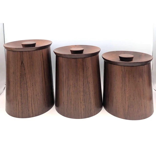 Offered are 3 Gladmark brand Teak wood kitchen canisters that have matching wood lids, 1 that is Teak (on the larger...