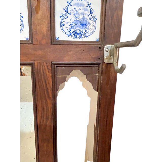 Antique English walnut coat hat rack. Mirror in the center and two empty panels on either side that probably had mirrors...