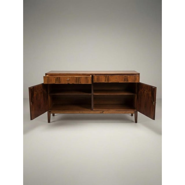 Upgrade your space with this 1960s Model 5 sideboard, designed by Gunni Omann for Omann Jun Møbelfabrik. Gunni Omann was a...