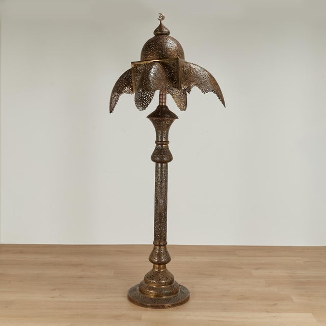 Exotic antique Moroccan floor lamp crafted in brass and copper perforated in geometric designs featuring a crescent moon...
