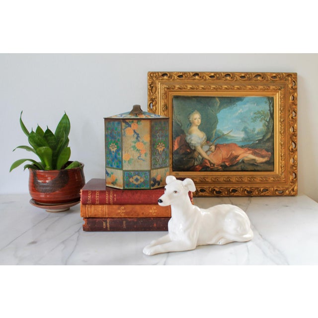 Octagonal-shaped, vintage or antique tin, likely from England, featuring a Chinoiserie-style design with floral and leaf...