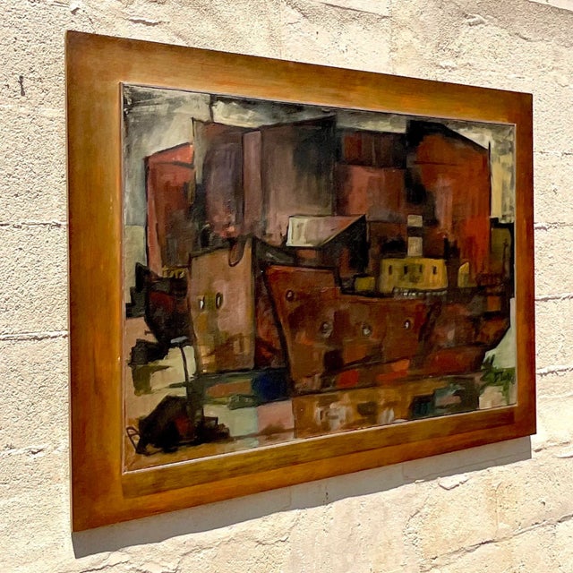 This vintage mid-century modern (MCM) abstract cubist painting depicts an urban cityscape in rich, muted tones of reds,...