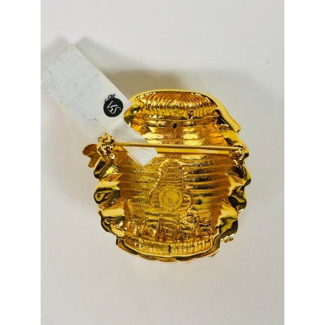 This stunning St. John brooch features a golden honey bee hive articulated in gold tone with marquis-shaped crystals...