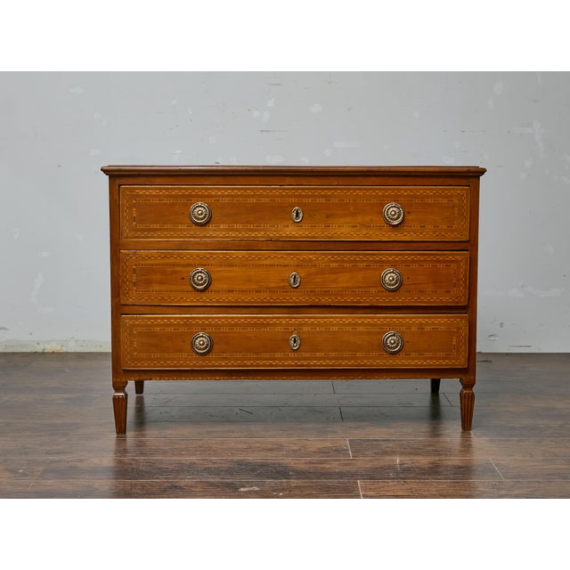 A French 19th-century walnut commode in the Louis XVI style, this piece showcases refined craftsmanship with its geometric...