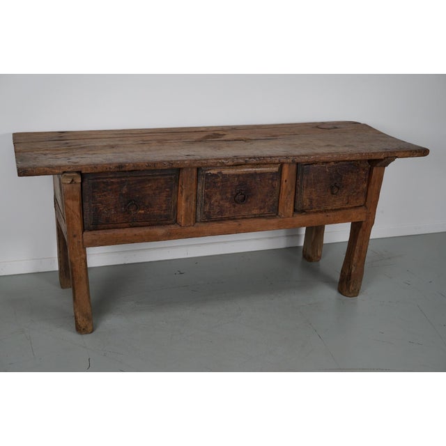 This elegant table was made in Spain from chestnut with beautiful grain patterns. It has a warm color with many marks of...