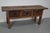 This elegant table was made in Spain from chestnut with beautiful grain patterns. It has a warm color with many marks of...