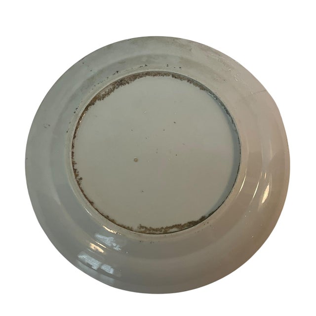 This is a Chinese Famille Rose export plate, typically featuring vibrant enameled floral and bird motifs, dating from the...