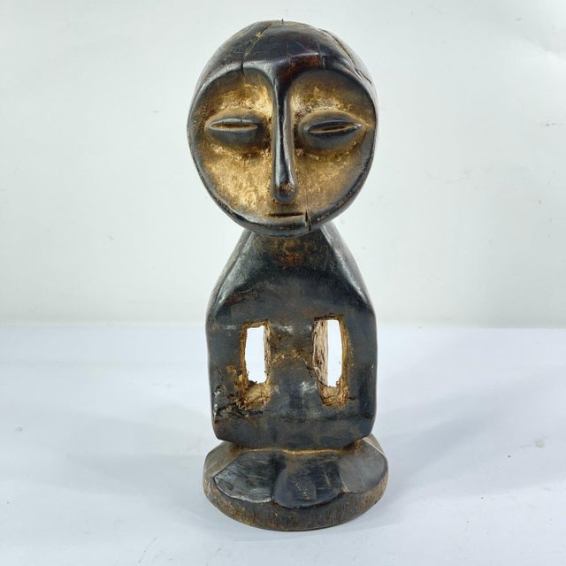 A hand-carved Lega figure originates from the Lega people in the Democratic Republic of the Congo. The figure is easily...