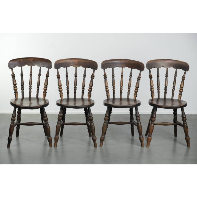 We are offering this set of 4 antique English wooden Windsor pub/bistro chairs from the 19th century with a beautiful...