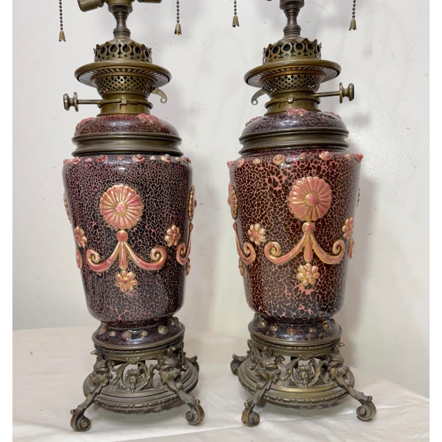 This rare pair of antique 19th century Hinks & Sons Duplex electrified bronze mounted porcelain oil lamps are a unique and...