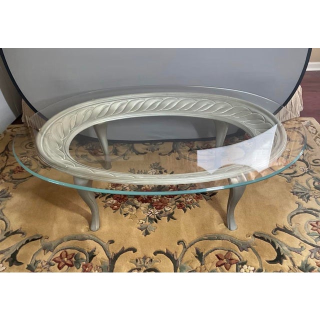 An exceptional, grand-scale vintage Hollywood Regency oval cocktail table featuring an Italian hand-forged and cast...