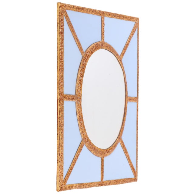 A striking artist-made wall mirror featuring a bold geometric design and a sophisticated interplay of color, texture, and...