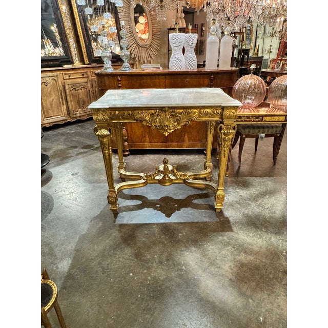 The 19th c. French Louis XV Giltwood Console is a luxurious and elegant piece of furniture that exudes sophistication and...