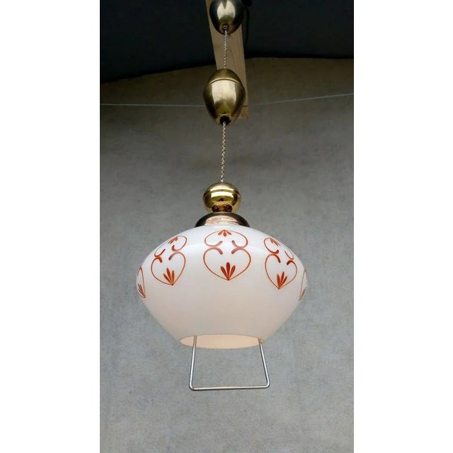 Nice authentic retro vintage chandelier, golden color holder with patina, white glass with ornament, adjustable height 55...