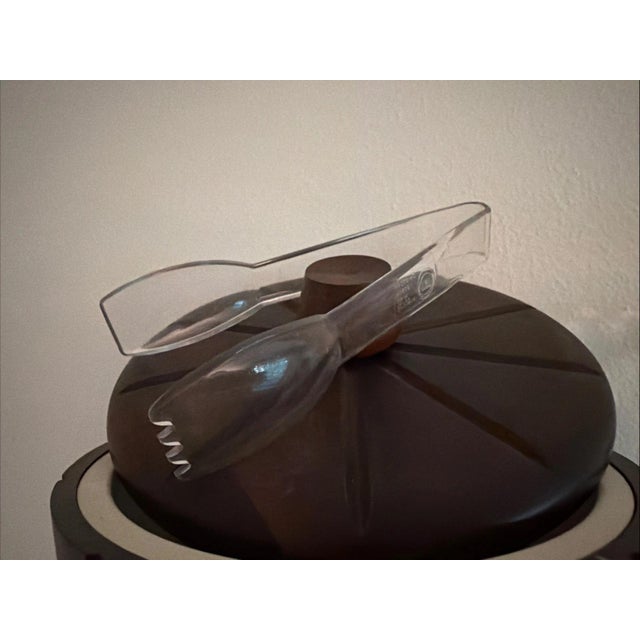 This stylish Mid Century Modern set includes a stylish wooden ice bucket and tongs, along with a decanter and 4 gold...