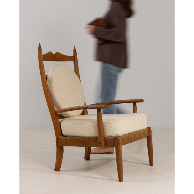 This piece presents as a armchair, distinguished by natural oak carved frame, cream upholstered seat/back. It was made in...
