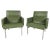 A beautiful pair of vintage modern armchairs with metal legs and tufted green vinyl upholstery. The wonderful design...