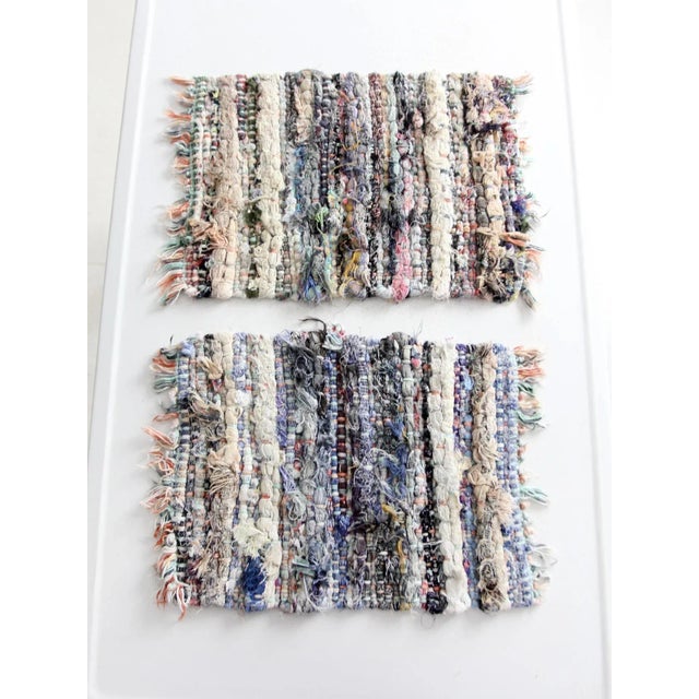 This pair of vintage handmade rag rug placemats features a thick, knotted weave with fringe ends. Woven in muted tones...