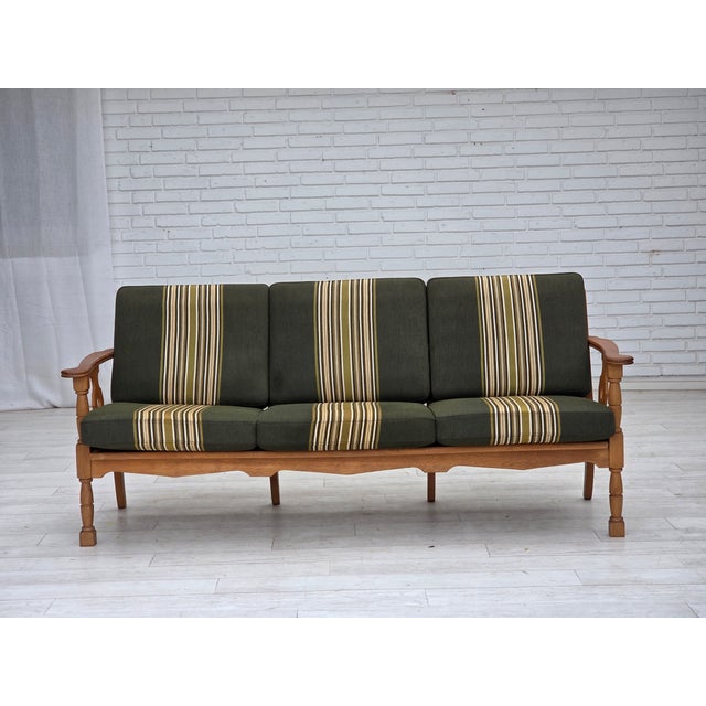 1970s, Danish 3-seater sofa. Original striped green furniture wool, solid oak wood, springs in the seat cushions. Original...