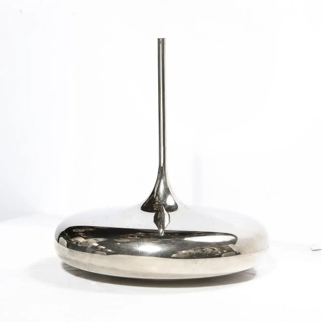 This highly stylized vase features a sculptural sinuous design with a elongated neck. A wonderful object as well as a...