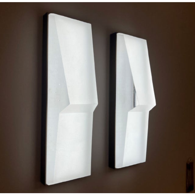 Modern with a jewel-like form, the Prism Sconce is composed of a faceted cast glass diffuser set within a brass frame and...