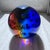 A striking monumental art glass orb or giant paper weight featuring vivid cobalt blue, amber, green, and clear sommerso-...