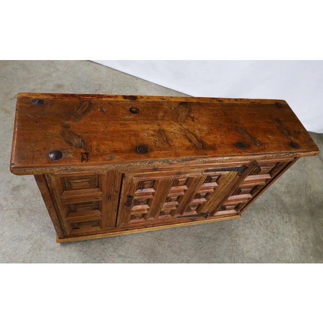 A character-rich 18th-century Spanish sideboard distinguished by bold, architectural paneling and a beautifully timeworn...