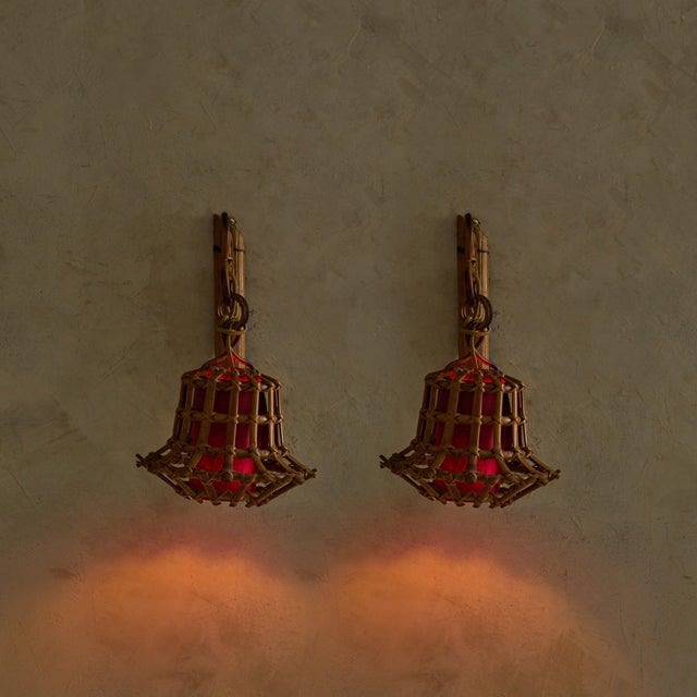 A pair of Italian wall sconces from the 1970s, combining bent bamboo, woven rattan, and warm, saturated color. Each sconce...