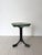 An unusual French wooden side table with splayed iron legs culminating in block feet. The circular timber top has been...