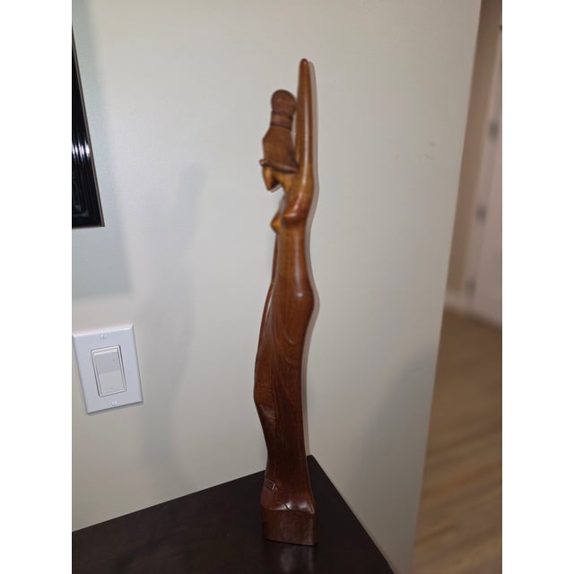 An extraordinary mid-century Balinese modernist sculpture depicting a stylized, statuesque maiden by the highly celebrated...