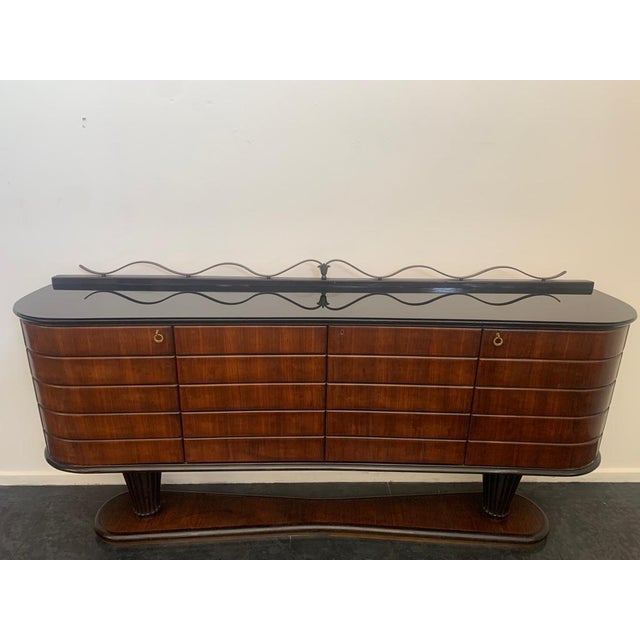 Vittorio Dassi sideboard The elegantly oval base narrows towards the centre. Profiled, it is outlined above by ebonising...