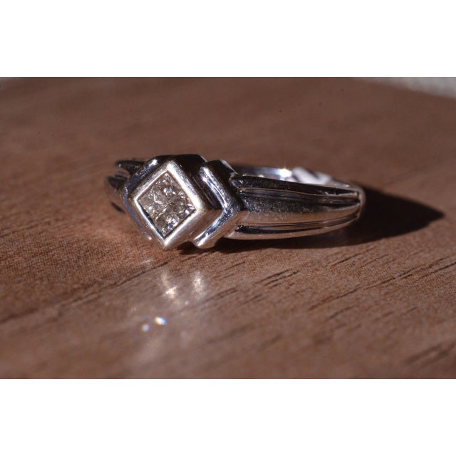 The Aubrey Modern Minimalist Ring in 14 Karat White Gold set with Diamonds. The center section is mystery set with four...