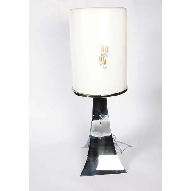 This table lamp with a Murano glass shade was produced in the 1960s. Up to 250V (Europe/UK Standard).The wiring of this...