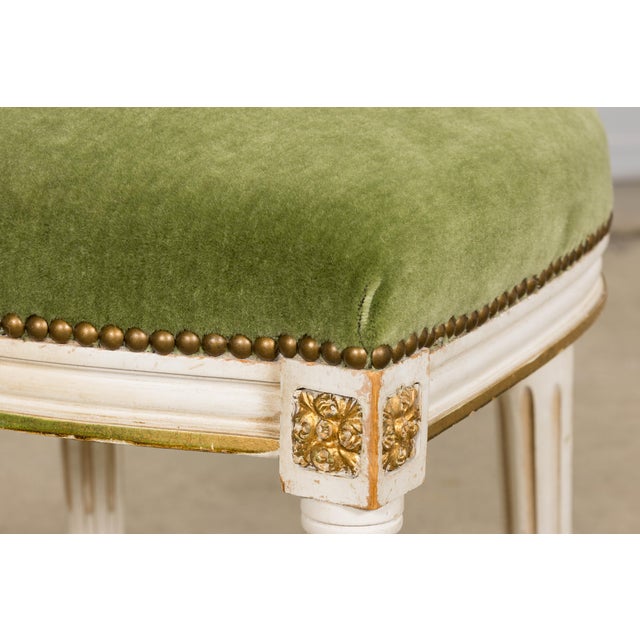A refined French Louis XVI style accent chair sourced in Paris, dating to the early 20th century. The chair features a...