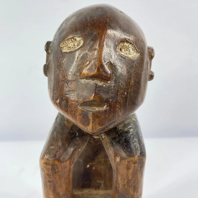 A hand-carved Lega figure originates from the Lega people in the Democratic Republic of the Congo. The figure is easily...