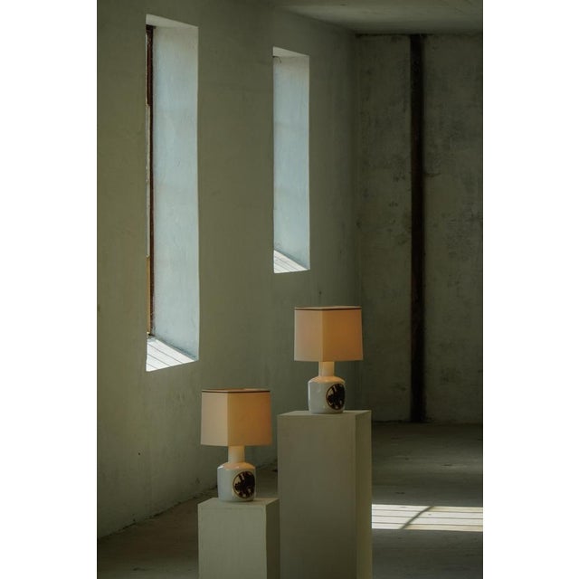 A charming pair of Danish porcelain table lamps produced by Bing & Grøndahl, Denmark, during the 1960-1970s. The lamps...