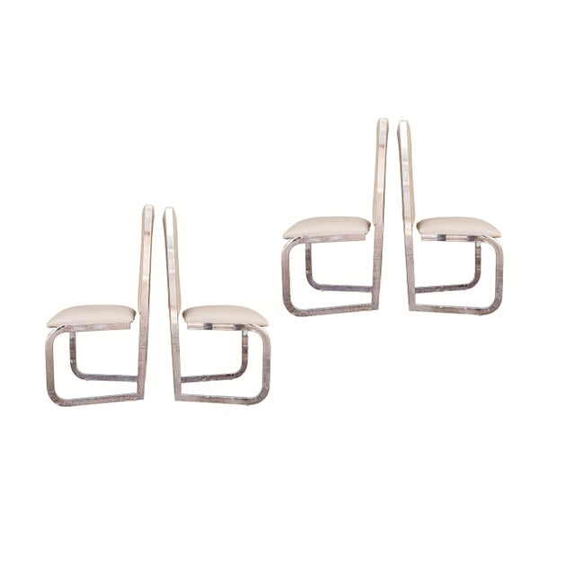 Stunning set of four Milo Baughman style high-back dining chairs. These chairs feature a sleek, architectural flat-bar...