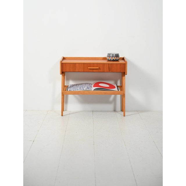Scandinavian bedside table from the 1950s and 1960s in light wood, featuring a light and balanced structure, with an upper...