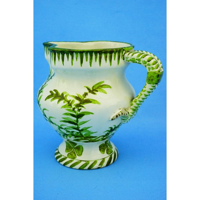 MEASUREMENTS: Height: 13.7 cm; Width: 15 cm; Depth: 12 cm; Weight: 0.437 kg Item : A refined small jug in glazed and...