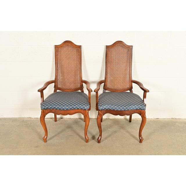 A gorgeous pair of French Provincial Louis XV style armchairs or dining captain chairs In the manner of Baker Furniture...