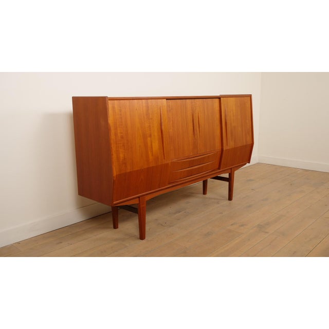 Fantastic vintage Danish highboard with sliding doors and beautiful drawers underneath, giving it an insanely beautiful...