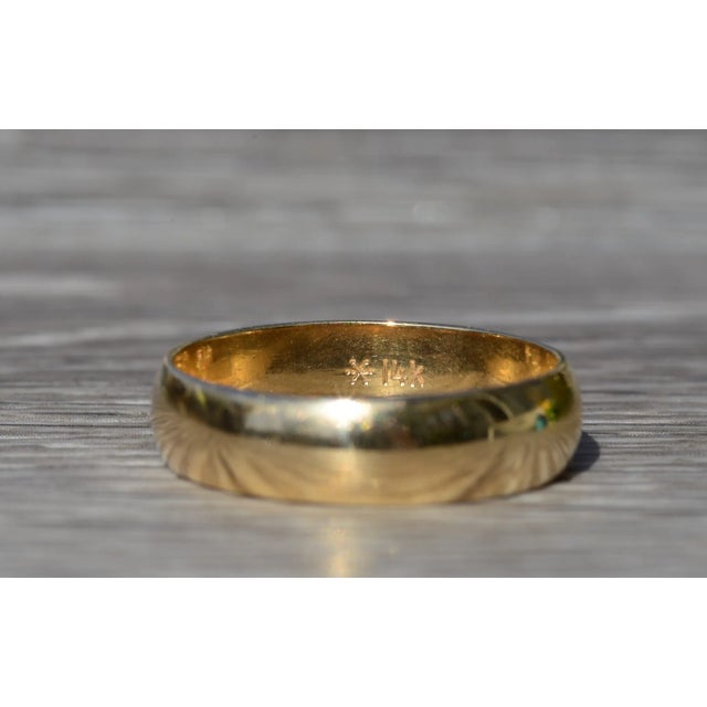 Men's 14K Yellow Gold Wedding Band. Crafted in 14 karat yellow gold, this men's standard fit wedding band measures 5.5mm...