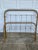 Heavy duty full sized cast iron bed frame with shell pattern. Has been painted a brown gold color. There is some pitting...