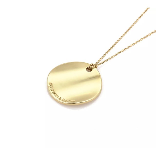 Elegant and authentic from Tiffany & Co. from the NOTES collection. This pendant and chain is well crafted from 18k yellow...