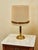 Elegant vintage lamps with a brass patinated leg and a fabric shade in a beige shade. The classic design with subtle gold...